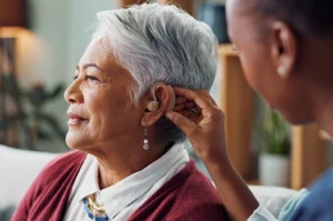 hearvana nurse woman and hearing aid on ear