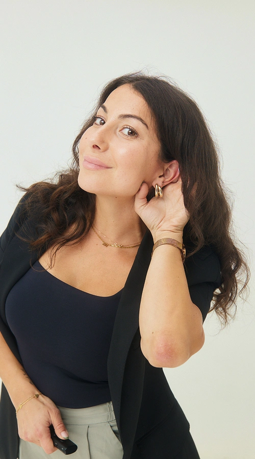 hearvana woman smiling cupping ear black outfit
